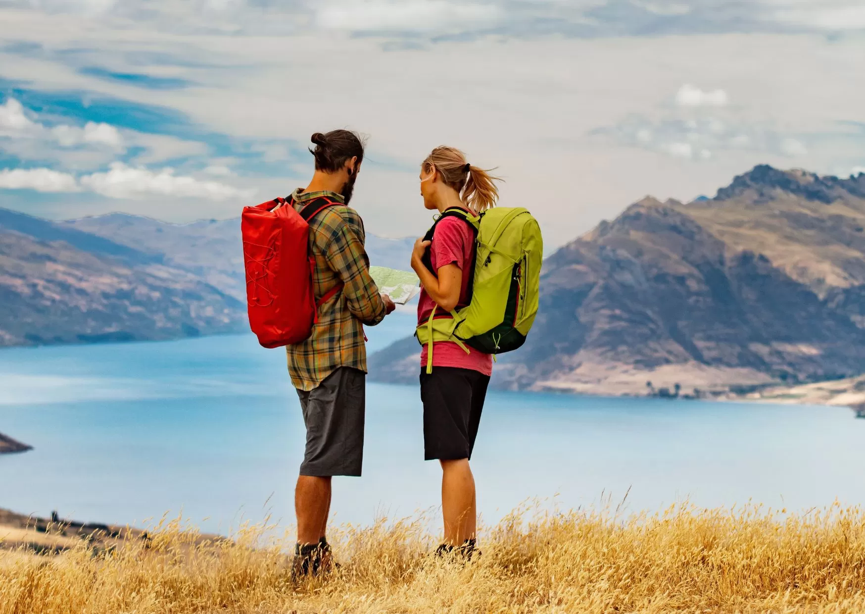 Hikers looking out at mountains and lake.  